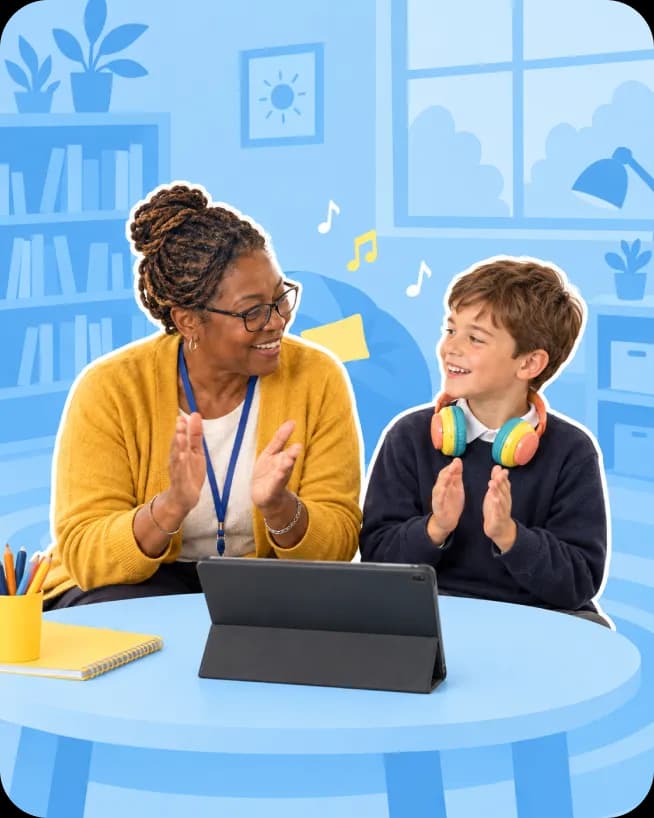 A teacher and a pupil wearing headphones clap together beside a tablet